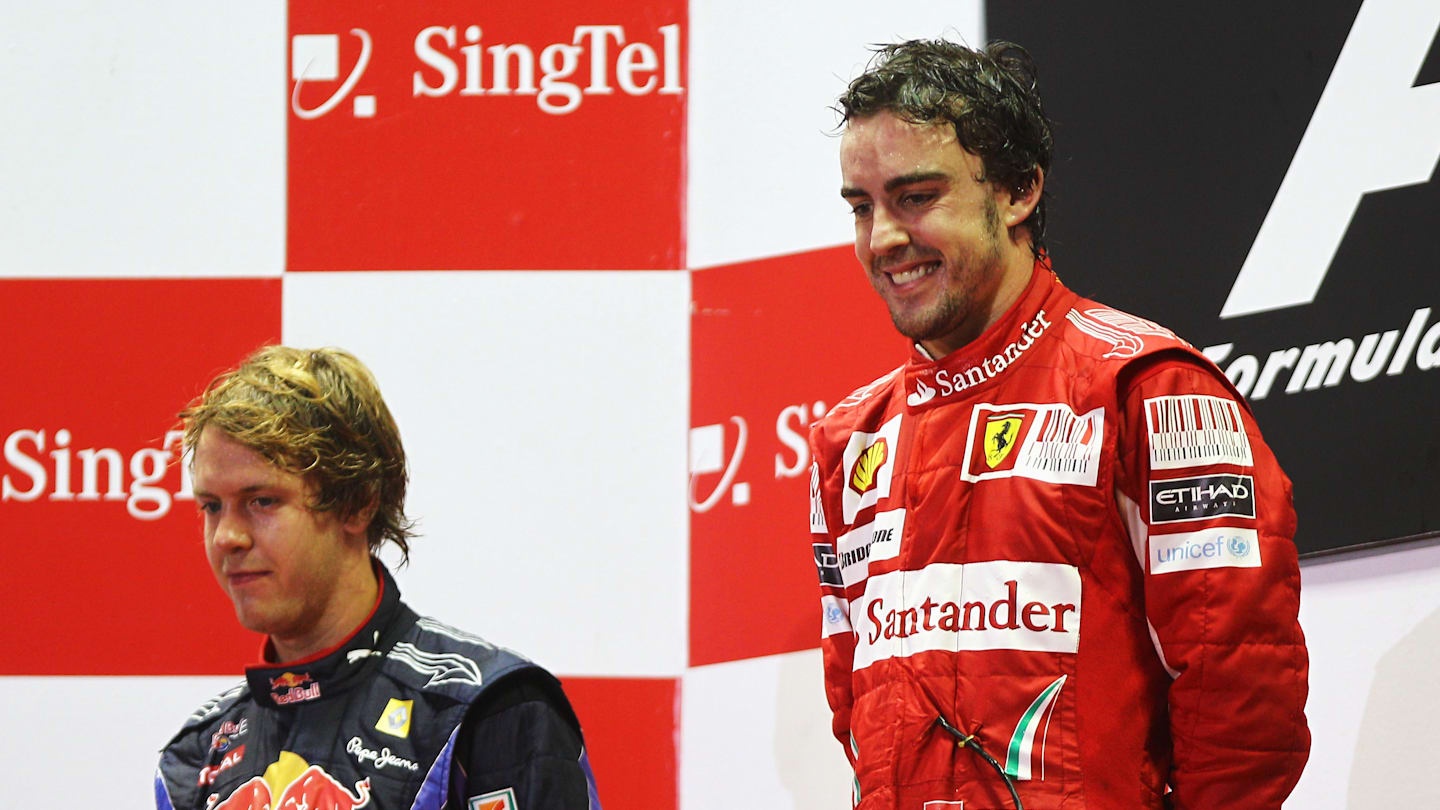 SINGAPORE - SEPTEMBER 26:  Race winner Fernando Alonso (R) of Spain and Ferrari celebrates on the