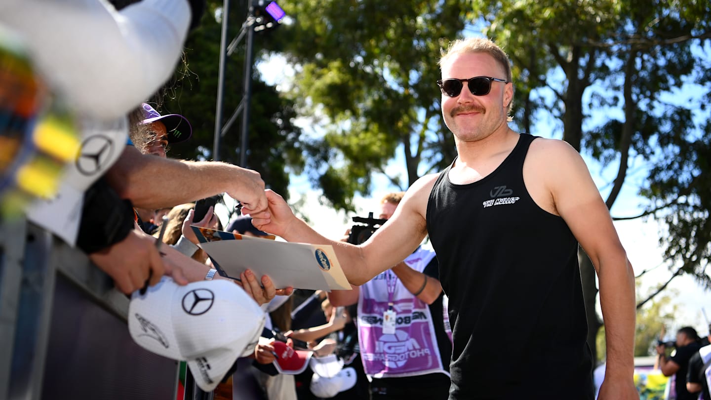 MELBOURNE, AUSTRALIA - MARCH 30: Valtteri Bottas of Finland and Alfa Romeo F1 greets fans at the