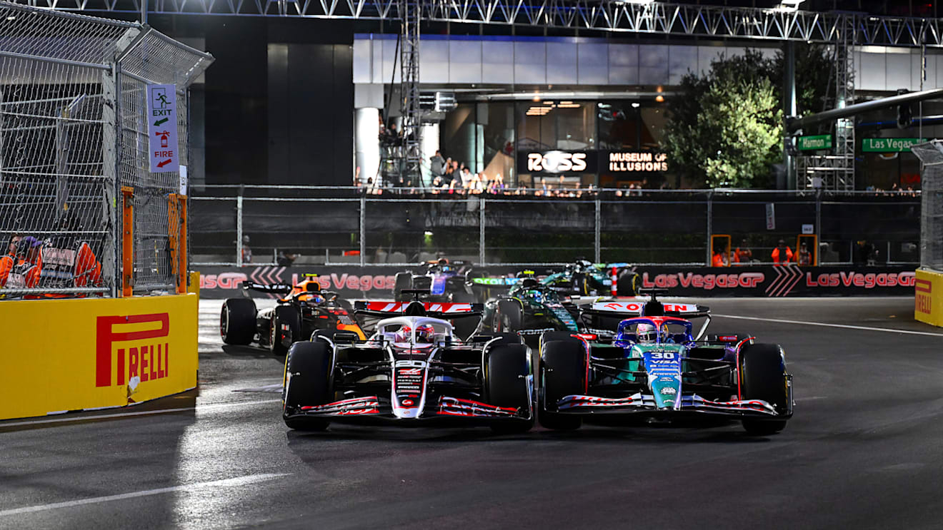 LAS VEGAS, NEVADA - NOVEMBER 23: Kevin Magnussen of Denmark driving the (20) Haas F1 VF-24 Ferrari and Liam Lawson of New Zealand driving the (30) Visa Cash App RB VCARB 01 compete for track position during the F1 Grand Prix of Las Vegas at Las Vegas Strip Circuit on November 23, 2024 in Las Vegas, Nevada. (Photo by Mark Sutton - Formula 1/Formula 1 via Getty Images)