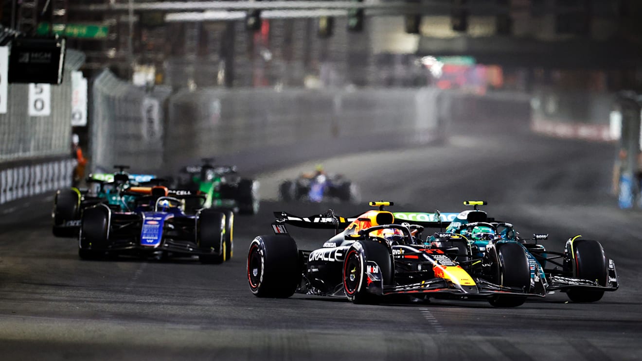 LAS VEGAS, NEVADA - NOVEMBER 23: Sergio Perez of Mexico driving the (11) Oracle Red Bull Racing RB20 and Fernando Alonso of Spain driving the (14) Aston Martin AMR24 Mercedes compete for track position during the F1 Grand Prix of Las Vegas at Las Vegas Strip Circuit on November 23, 2024 in Las Vegas, Nevada. (Photo by Chris Graythen/Getty Images)