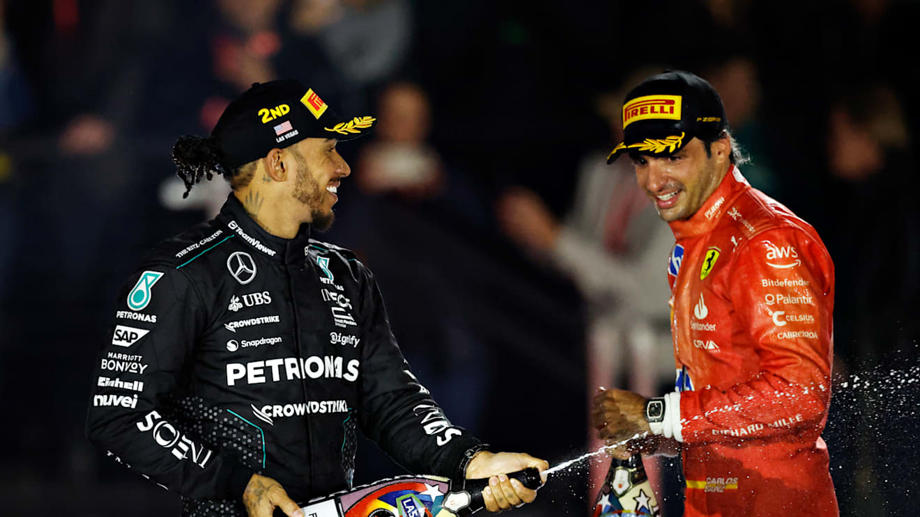 LAS VEGAS, NEVADA - NOVEMBER 23: Second placed Lewis Hamilton of Great Britain and Mercedes and Third placed Carlos Sainz of Spain and Ferrari celebrate on the podium during the F1 Grand Prix of Las Vegas at Las Vegas Strip Circuit on November 23, 2024 in Las Vegas, Nevada. (Photo by Chris Graythen/Getty Images)