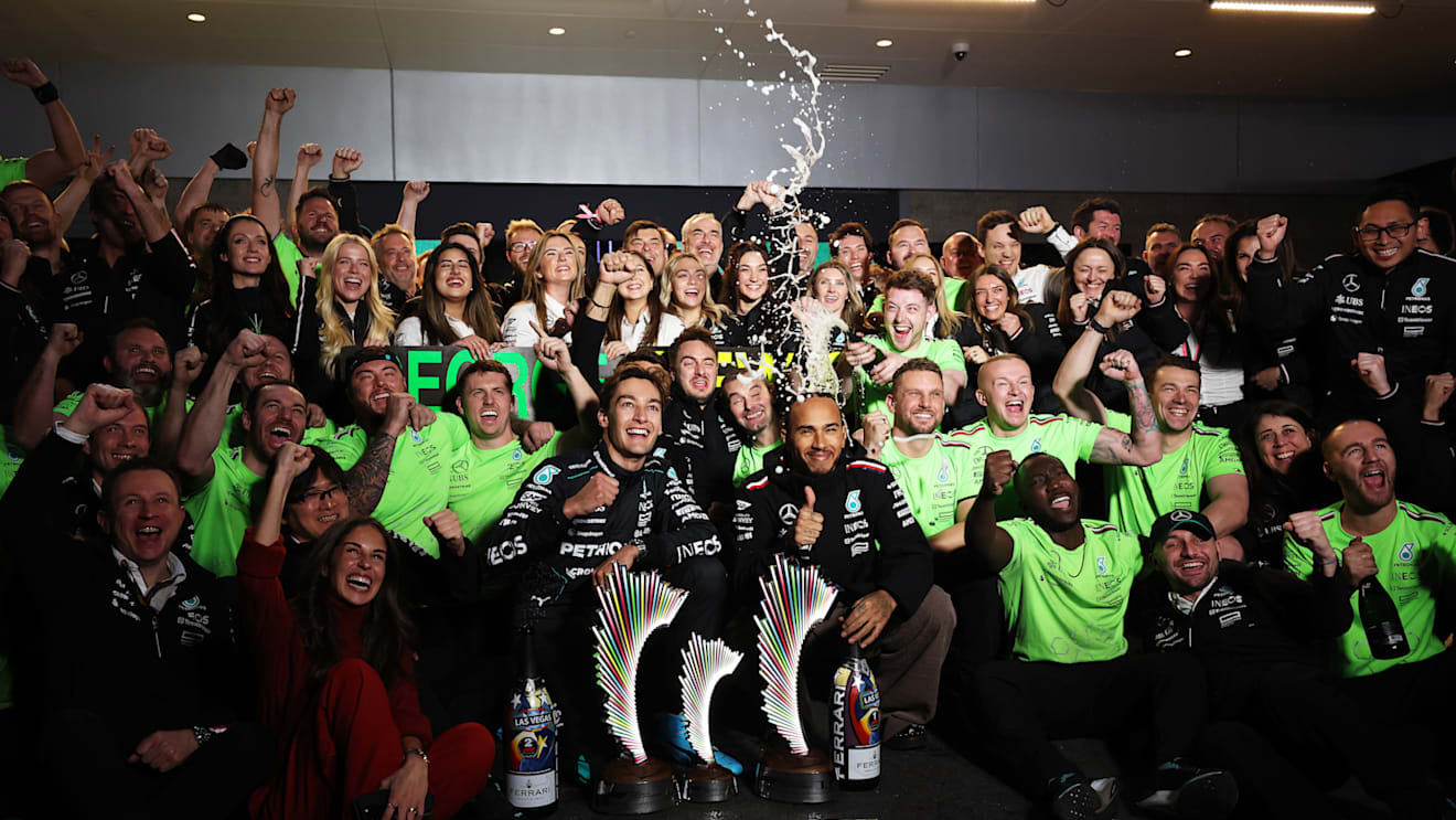 LAS VEGAS, NEVADA - NOVEMBER 23: Race winner George Russell of Great Britain and Mercedes and Second placed Lewis Hamilton of Great Britain and Mercedes celebrate with their team in the Pitlane after the F1 Grand Prix of Las Vegas at Las Vegas Strip Circuit on November 23, 2024 in Las Vegas, Nevada. (Photo by Meg Oliphant - Formula 1/Formula 1 via Getty Images)