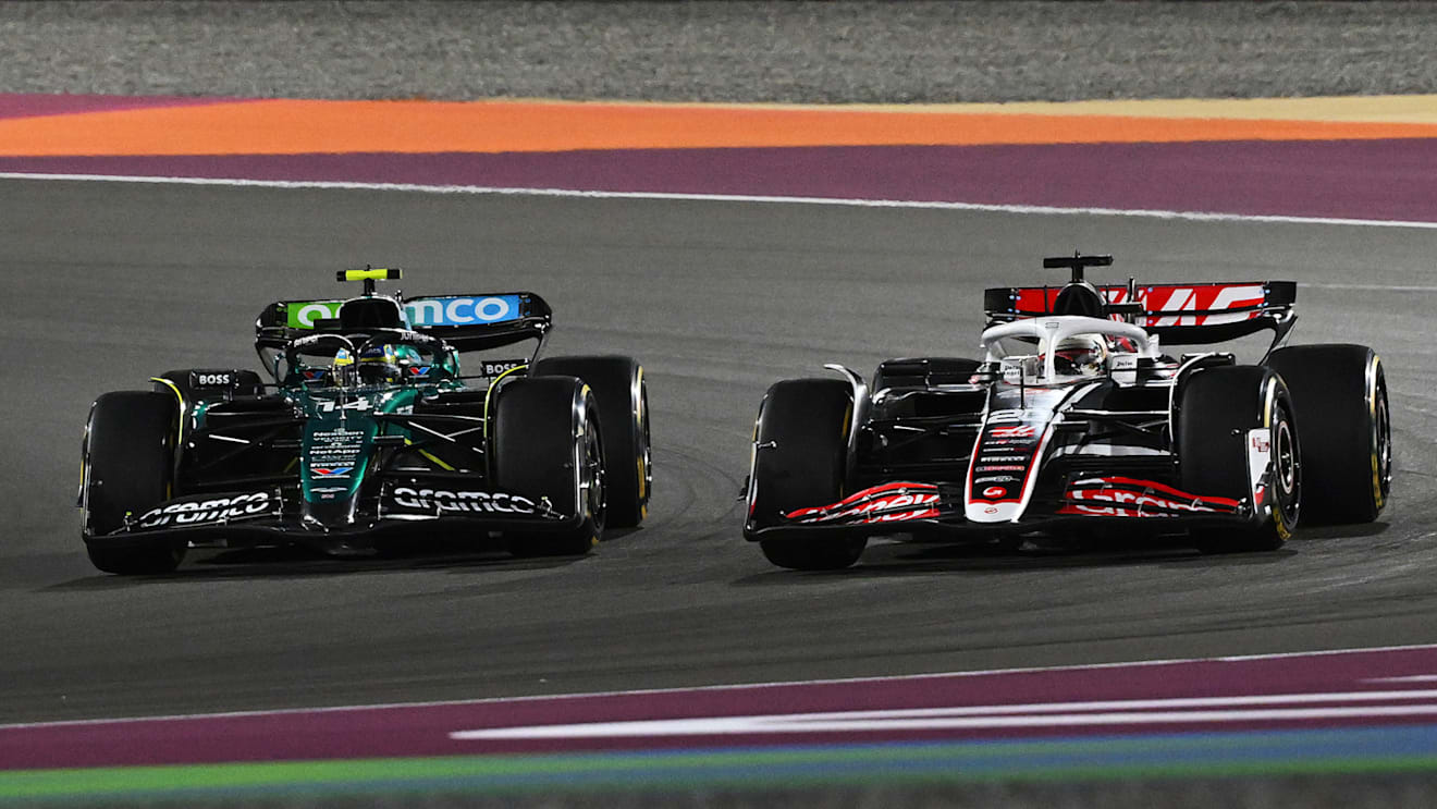 LUSAIL CITY, QATAR - NOVEMBER 30: Fernando Alonso of Spain driving the (14) Aston Martin AMR24 Mercedes and Kevin Magnussen of Denmark driving the (20) Haas F1 VF-24 Ferrari battle for track position during the Sprint ahead of the F1 Grand Prix of Qatar at Lusail International Circuit on November 30, 2024 in Lusail City, Qatar. (Photo by Mark Sutton - Formula 1/Formula 1 via Getty Images)