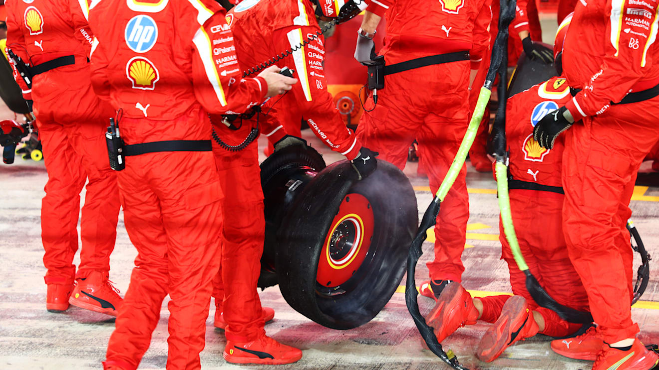 LUSAIL CITY, QATAR - DECEMBER 01: Ferrari team members hold the punctured tire of Carlos Sainz of Spain and Ferrari in the Pitlane during the F1 Grand Prix of Qatar at Lusail International Circuit on December 01, 2024 in Lusail City, Qatar. (Photo by Peter Fox/Getty Images)