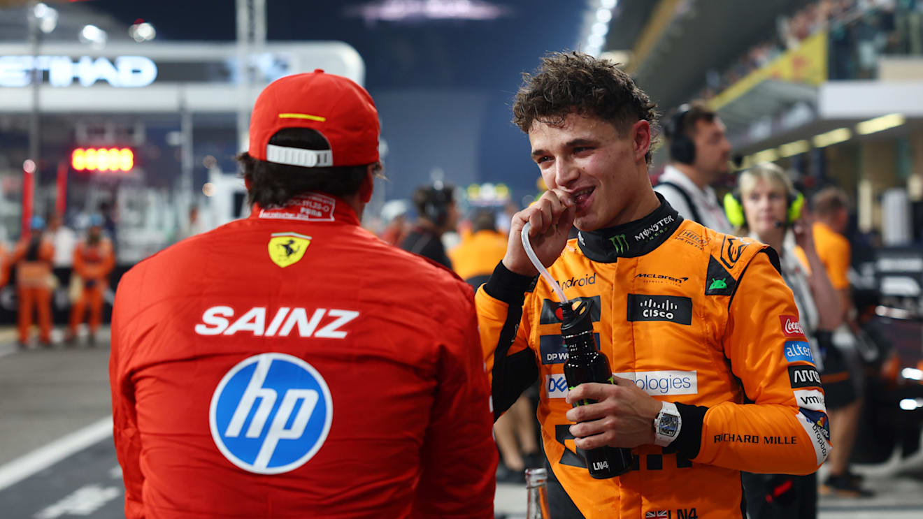 ABU DHABI, UNITED ARAB EMIRATES - DECEMBER 07: Pole position qualifier Lando Norris of Great Britain and McLaren and Third placed qualifier Carlos Sainz of Spain and Ferrari talk in parc ferme during qualifying ahead of the F1 Grand Prix of Abu Dhabi at Yas Marina Circuit on December 07, 2024 in Abu Dhabi, United Arab Emirates. (Photo by Bryn Lennon - Formula 1/Formula 1 via Getty Images)