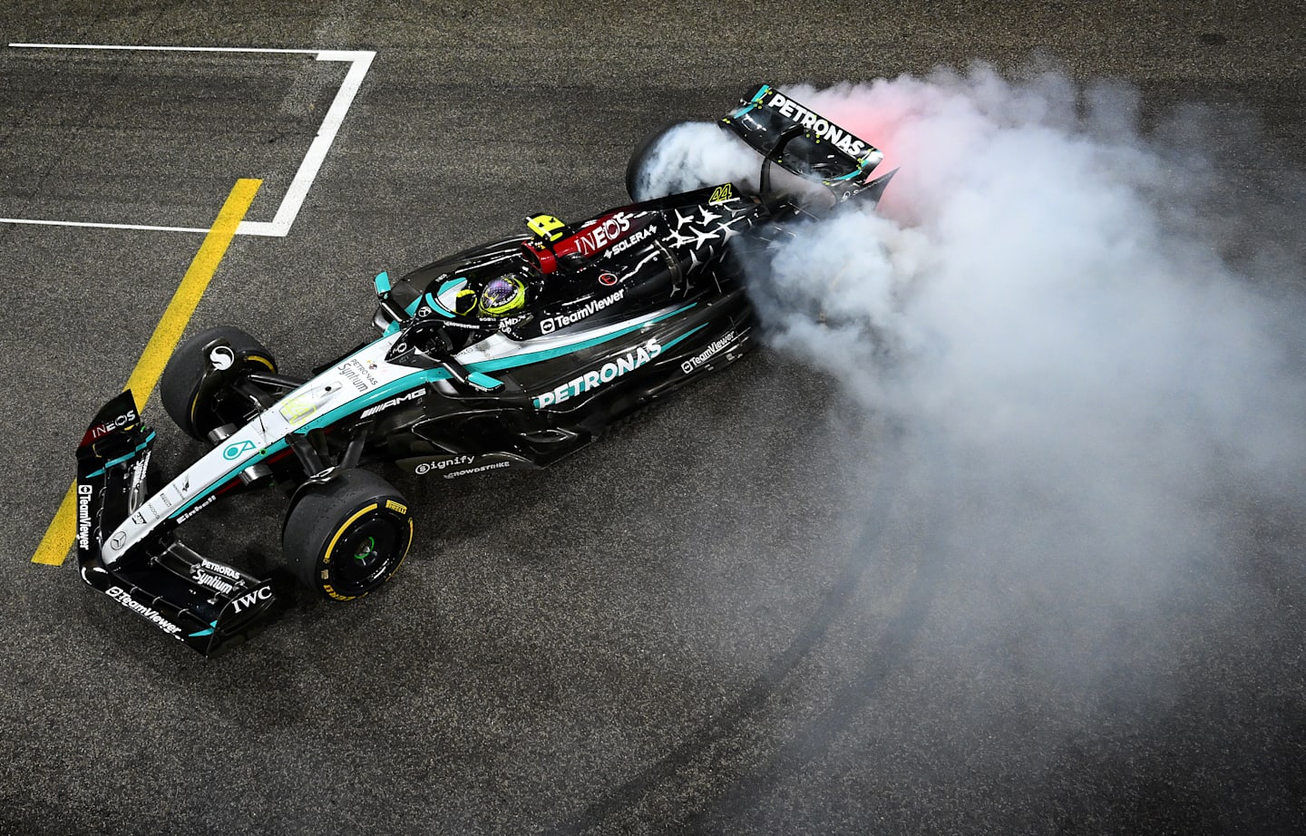 Lewis Hamilton driving the (44) Mercedes AMG Petronas F1 Team W15 does donuts on track to celebrate his final race with Mercedes during the F1 Grand Prix of Abu Dhabi at Yas Marina Circuit on December 08, 2024. (Photo by Clive Mason/Getty Images)